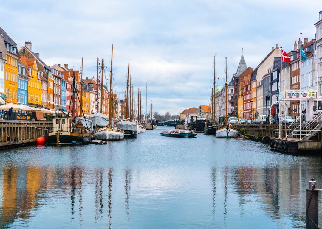 Old Copenhagen harbor houses reflected in water