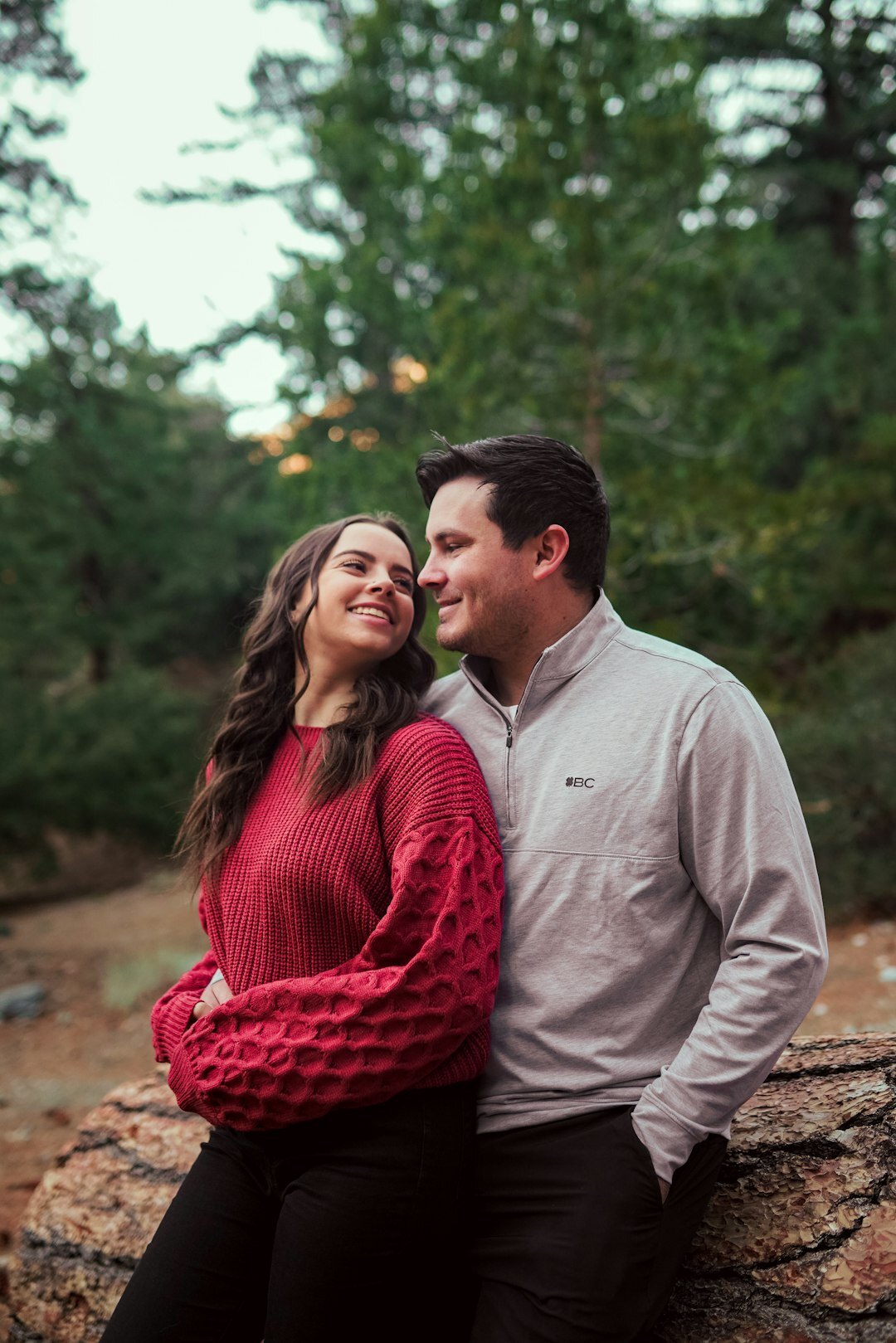 Candid engagement portrait of a couple laughing