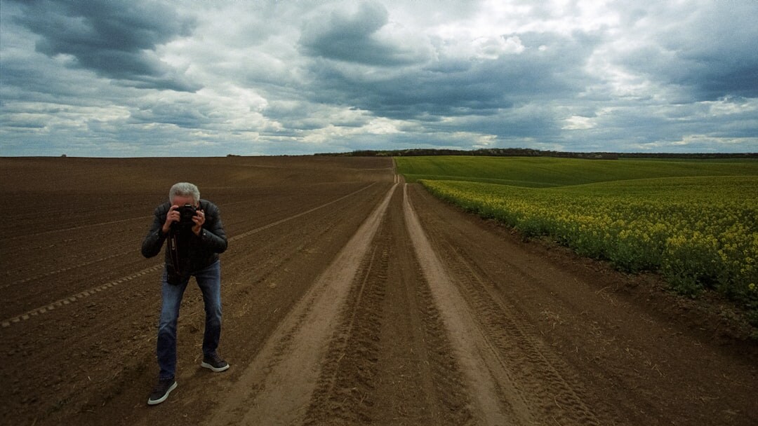 photographer with camera in field